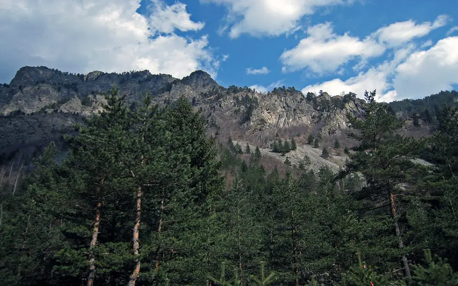 Photo source: bg.wikipedia.org  If you love nature and dream of admiring the views of ancient forests, snow-capped peaks and endless blue lakes, we offer you a short trip to one of the most beautiful lakes in our country - Elenino Lake. Where is? Elenino Lake is located in the Rila Mountains and is the largest of the three lakes that form a lake group called Elena Lakes.  The lake is located at 2479 meters above sea level, and in its waters are reflected four of the most beautiful peaks in Rila - Orlovets, Malyovitsa, Popova Kapa and Golyam Kupen.  In terms of size, the lake can hardly be ranked among the largest lakes in the mountain, but with its length of 220 meters, width of 62 meters and depth of up to 5 meters is the largest and most beautiful of the three Elena lakes.  Its shape is slightly elongated and irregular, and its shores are rocky. The lake is filled mainly by the melted snow.   Photo source: bg.wikipedia.org Legend of the lake Like almost all of the natural attractions, Elenino Lake has its own beautiful and very romantic legend. According to the story, many years ago, during the Turkish slavery, in Samokov lived a wonderfully beautiful girl named Elena.  One day the Turkish pasha Selim came to visit the town, there he saw Elena and asked the residents of Samokov to sell him the beautiful girl or otherwise he was going to take their property.  The headmans came together and did not think much, but sold the girl to Selim Pasha. However, Elena managed to escape while they were on the way to her new home, and she hid at the mountains. There she was met by the detachment of Malyo Voyvoda and the girl became part of his group.  The years passed, and the girl became one of the best archers of the detachment and did not miss a battle with the Turkish troops.  Driven by her desire for revenge, Elena does not allow herself to have feelings, but the heart is hard to command and she fell in love with the flag bearer of the group.  Although the girl loved him with all her heart, she did not confess her feelings to him because she believed that the revenge was more important than love.   Photo source: bg.wikipedia.org  And so one day Elena finally managed to find Selim Pasha and took revenge on him. She killed the Turk with a precision shot, but unfortunately during the shooting she was badly hurt.  Her partners, who saw that she was getting weaker and would not survive, took her high in the mountains and laid her on the shore of one of the most beautiful and clear lakes.  With the last of her strength, Elena finally confessed her love to her beloved and realized that because of the revenge she had lost the most important and valuable thing in life - her love.  After her death, Elena was buried on the shores of the lake, and it has been named after her ever since - Elenino Lake.   Photo source: luckybansko.bg How do you get there? As the lake is located on the way of the tourist trail for climbing Malyovitsa peak, the only way to reach it is to take the route. Route of Malyovitsa CMS - Malyovitsa peak  The route starts from Malyovitsa CMS in the Mecha Polyana area (about 20 km from Samokov).  You can reach the area by car, which you must leave in the parking lot in front of the CMS "Malyovitsa" and walk along the trail.   Photo source: bg.wikipedia.org   Stage 1 - Malyovitsa CMS - Malyovitsa hut  The distance from the center to the hut at a moderate pace and without much need for rest is about 35 - 40 minutes.  The path you have to follow is marked with blue and there are no forks, so there is nowhere to go wrong.  This stage of the route is of low difficulty and with a relatively small slope, so even if you are not one of the best prepared hikers, you won’t find it difficult.   Photo source: bg.wikipedia.org  Stage 2 - Malyovitsa hut - First and Second terrace  If you get to the hut, it is good to eat, relax and most of all do not forget to refill with water, because the steep slope starts up and there is no place to pour water.  After Malyovitsa hut you should follow the path marked with white & blue. The ascent becomes more difficult as the vegetation gradually decreases and the displacement increases little by little.  About half an hour after the hut you will reach the first terrace of the trail, where you can take another short break to relax and enjoy the views that will unfold in front of your eyes.  The ascent continues to the Second Terrace. The path you have to follow is now marked in red, but even if you don't pay much attention, you can't go wrong, as this is the only path that leads to Malyovitsa. The route to the Second Terrace has an acceptable slope, but the path becomes more and more rocky and there is almost no vegetation.  You will know that you have passed the Second Terrace when you see a large rock with memorial plaques placed on it. (Memorial plaques of Bulgarian climbers who died while climbing native and foreign peaks).   Photo source: bg.wikipedia.org   Stage 3 - Second terrace - Elenino Lake  If you decide to reach only Elenino Lake and not finish the trail by climbing Malyovitsa Peak, you don’t have a much transition left.  From the Second Terrace you will reach Elenino Lake in about an hour if you walk at a medium pace. You have to be more careful here, because the displacement is quite large, the path is extremely rocky, and there are several super steep places, so if you are not careful you can slip.  But if you manage to cope, we assure you, the moment you see the beautiful lake you will forget the exhaustion and fatigue.   Photo source: wikimapia.org   If you still have the strength after a 3 hours of walking and decide to make a little more effort and conquer the peak, you have to overcome only one more stage of the route.  Stage 4 - Elenino Lake - Malyovitsa Peak  In the beginning the ascent to the top is quite difficult, as the terrain has a large displacement and is very rocky. Fortunately, the steep area is not big and after overcoming it you will have to walk along the ridge of the mountain, where the terrain is flat and the views are amazing.    Photo source: bg.wikipedia.org  If you turn around and look back, you will see the whole group of Elena lakes, and if you look at the distant valley to the south you will see the Rila Monastery.  In about 30 minutes of climbing with medium difficulty you will reach your final destination - peak Malyovitsa. In front of you will be an incredible view of Mount Musala, the Ribnovo Lake, and if it is sunny and clear you can see in the distance Pirin and even Vitosha Mountains.